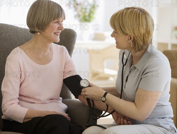 Senior woman having blood pressure taken.