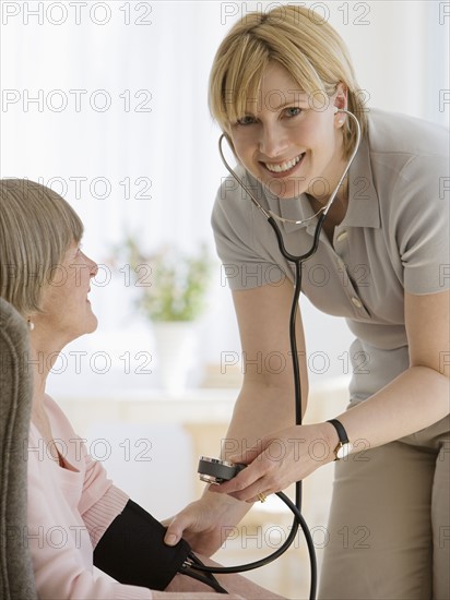 Senior woman having blood pressure taken.