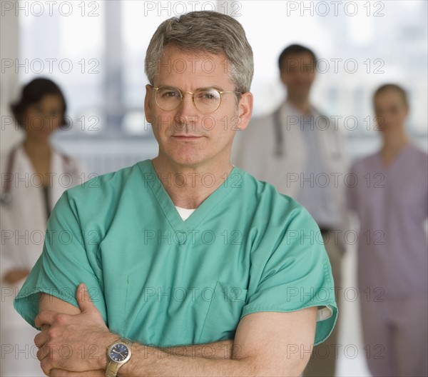 Male doctor wearing scrubs.