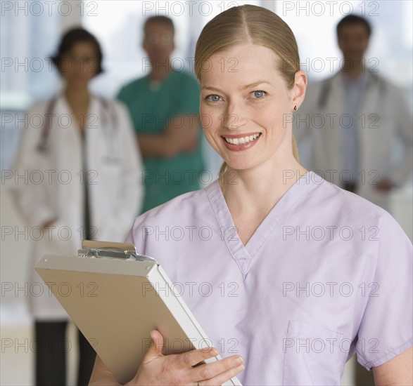 Female doctor holding chart.