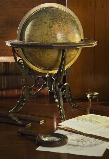 Old fashioned globe in stand on table.