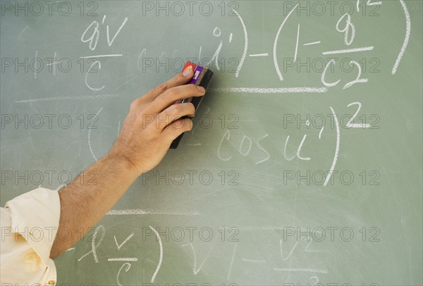 Professor erasing formulae on blackboard.