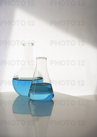 Two beakers with liquid.