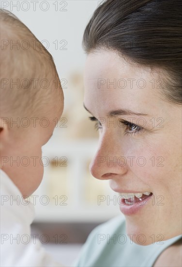 Mother smiling at baby.