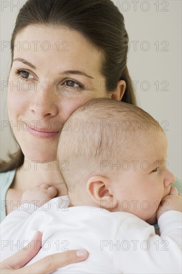 Mother hugging baby.