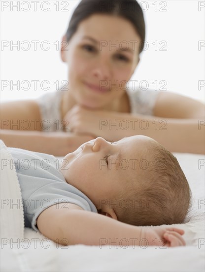 Mother watching baby sleep.