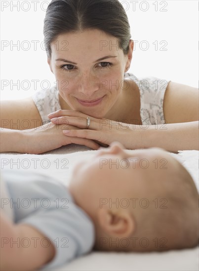 Mother watching baby sleep.