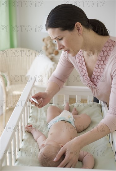 Mother checking baby’s temperature.