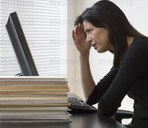 Businesswoman looking at computer.