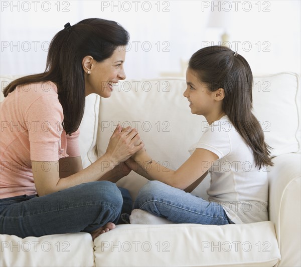 Mother and daughter smiling at each other.