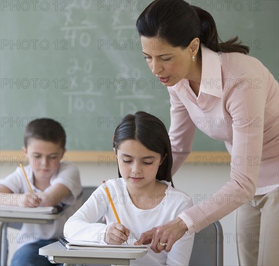 Female teacher helping student.