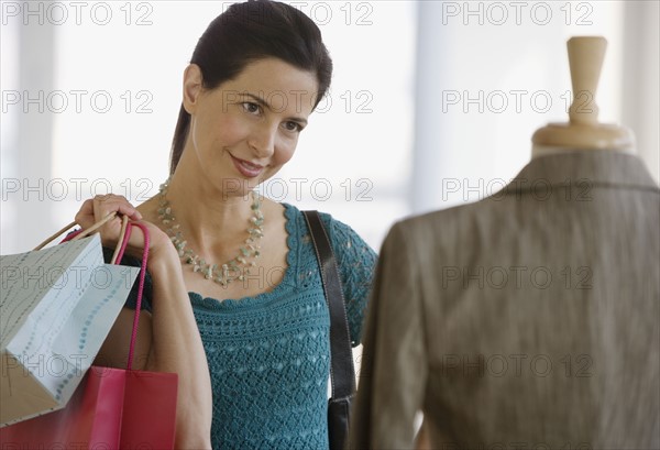 Woman looking at clothing in store.