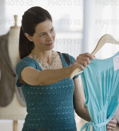 Woman looking at clothing in store.