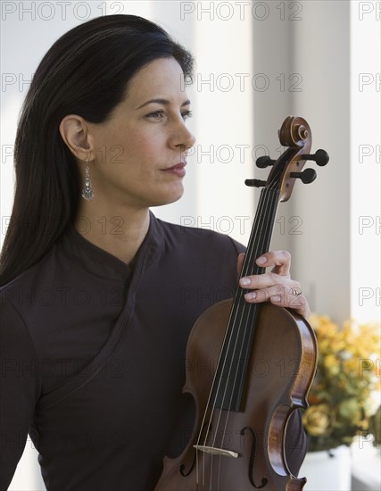 Woman holding violin.