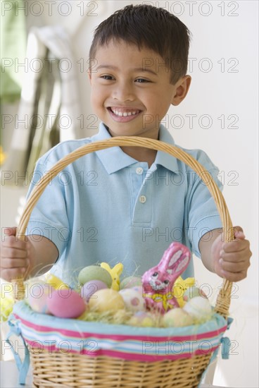 Asian boy holding Easter basket.