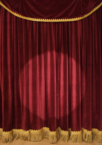 Spotlight on stage curtain.