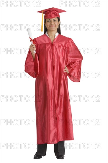 Indian woman wearing graduation cap and gown.