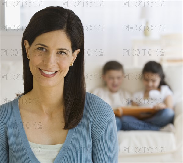 Mother with children in background.