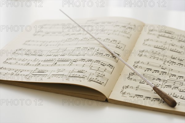 Conductor’s baton on sheet music.