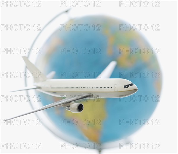 Model of airplane in front of globe.