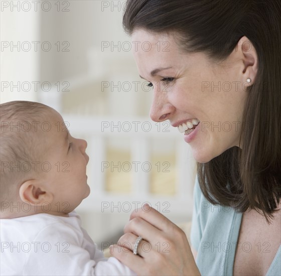 Mother smiling at baby.