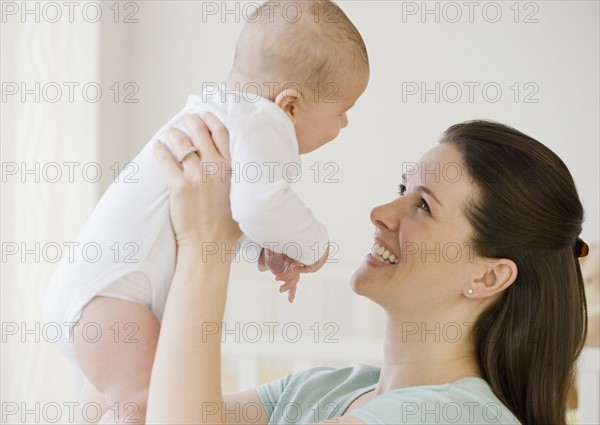 Mother smiling at baby.