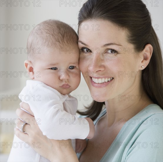 Mother hugging baby.