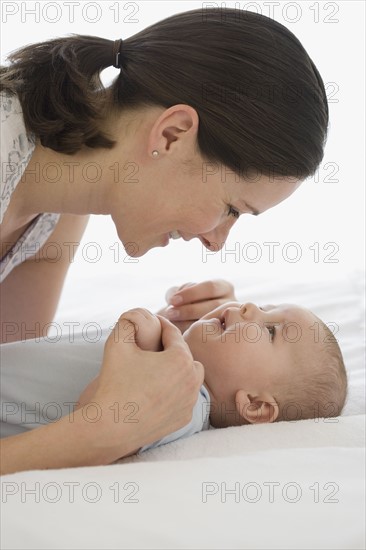 Mother smiling at baby.