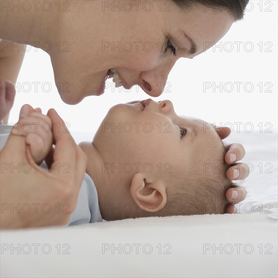 Mother smiling at baby.