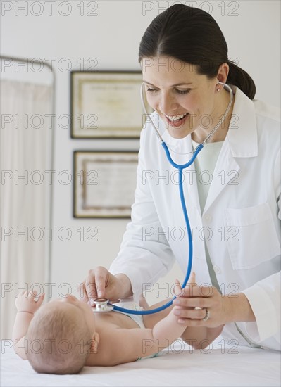 Female doctor examining baby.