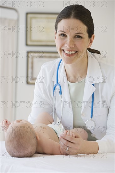 Female doctor examining baby.