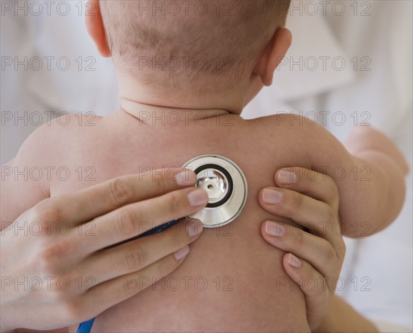 Doctor listening to baby’s lungs.