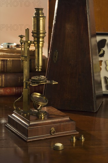 Old fashioned microscope on table.