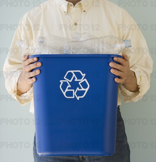 Man holding recycling bin.