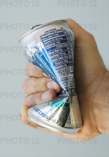 Man crushing tin can.