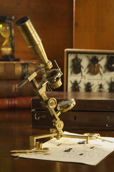 Old fashioned microscope on table.