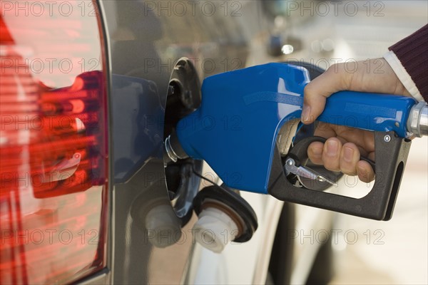 Man pumping gas.