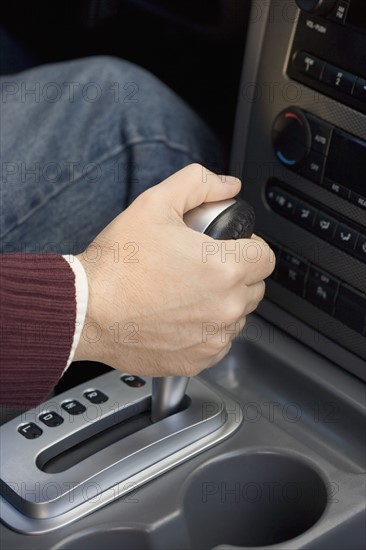 Man shifting automatic car.