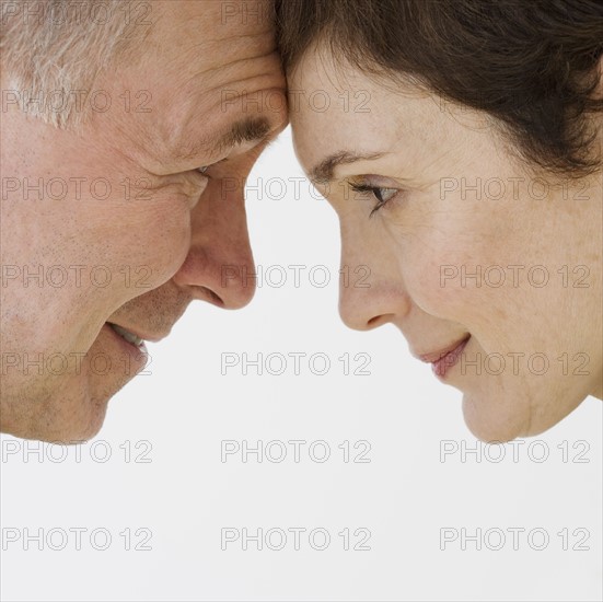 Close up of couple touching foreheads.