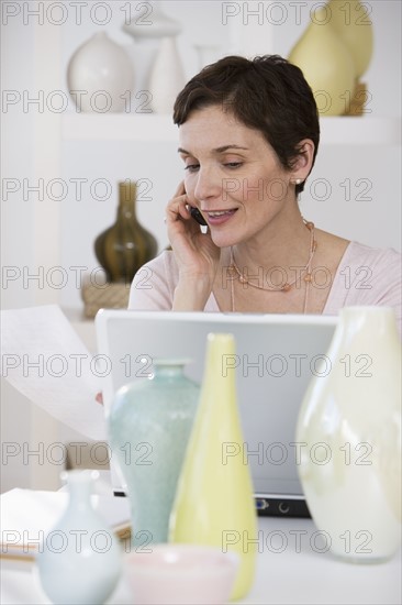 Woman working in pottery store.