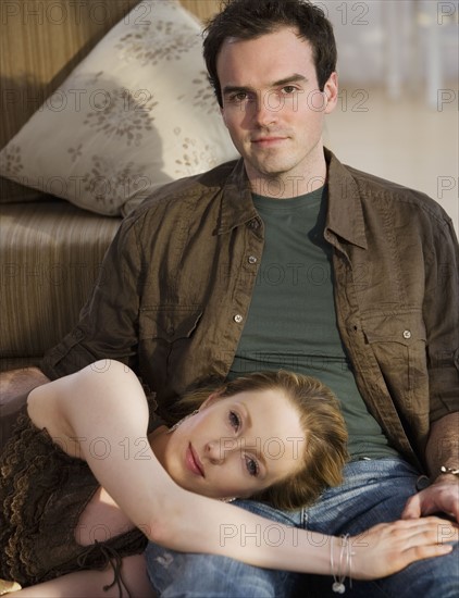 Woman laying head on boyfriend’s lap.