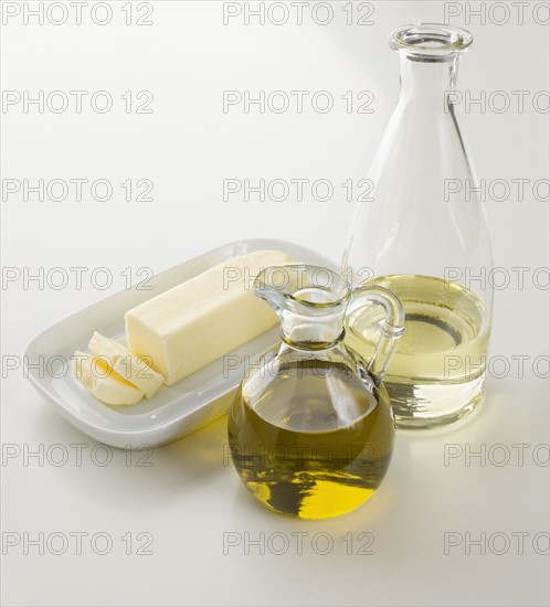 Butter, oil and water on table.
