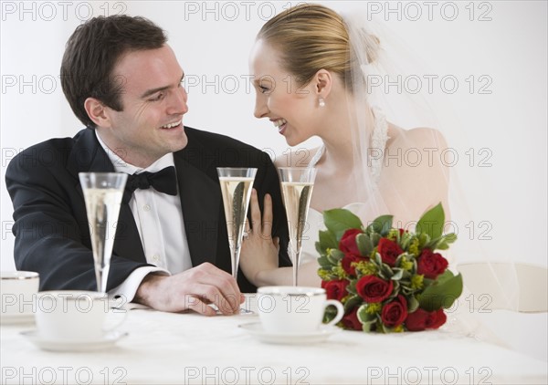 Bride and groom with champagne.