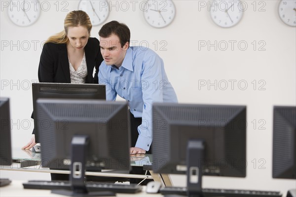 Businesspeople looking at computer.