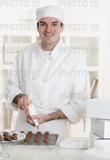 Male pastry chef in kitchen.