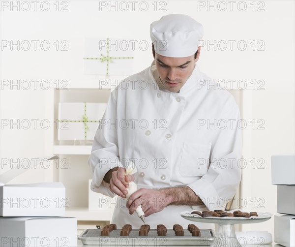 Male pastry chef in kitchen.