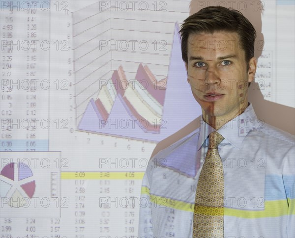 Businessman in front of graph projection.