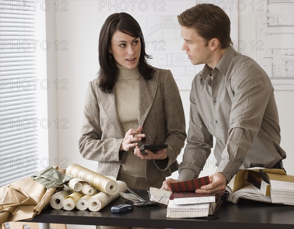 Interior designers working at shop.