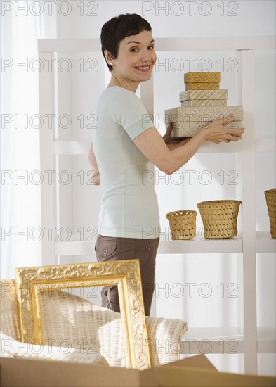 Woman unpacking moving boxes.