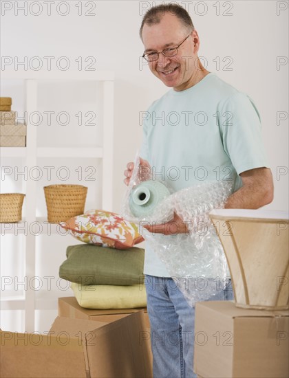 Man unpacking moving boxes.